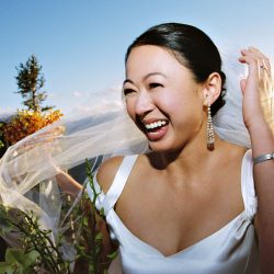 An exuberant bride just after the outdoor wedding ceremony at the Aspen Mountain Club. Shot on film.