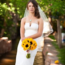 bride with sunflower bouquet in an outdoor garden